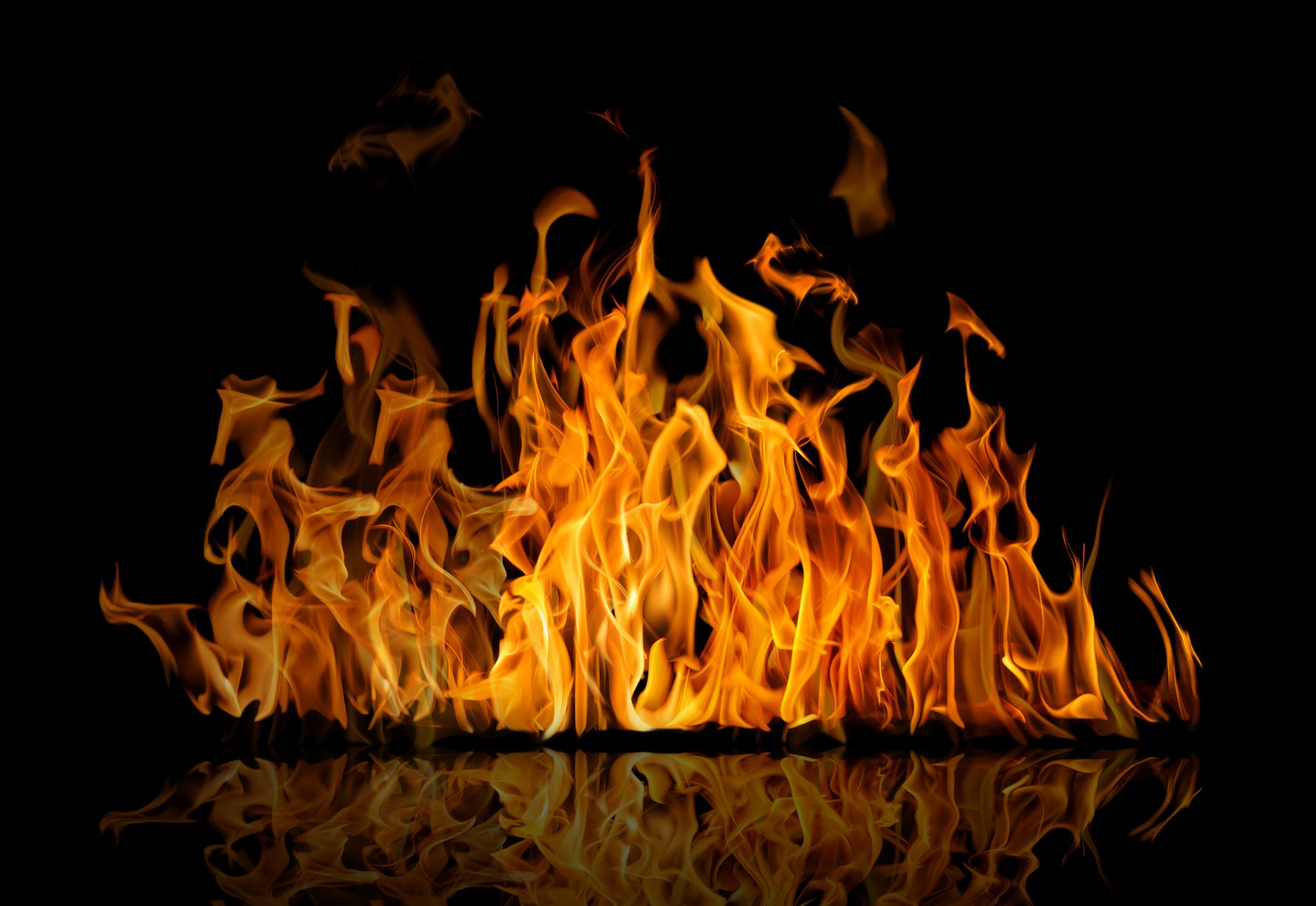 A picture of a fire burning in the dark.