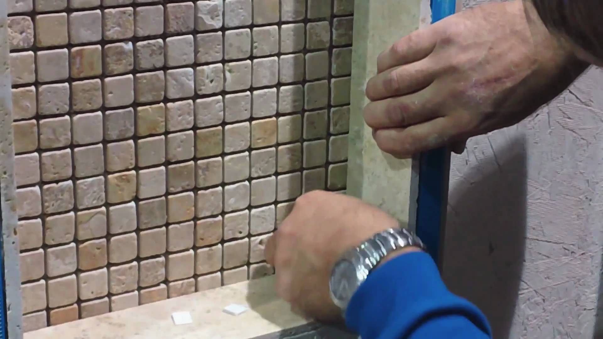 Professional installing tile in a bathroom. 