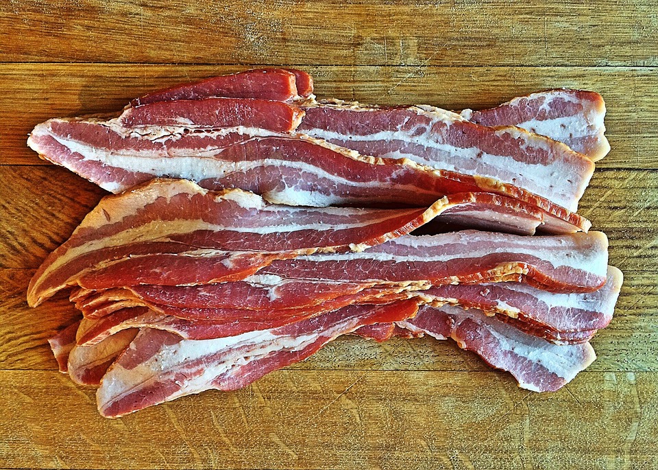 Slices of uncooked bacon.