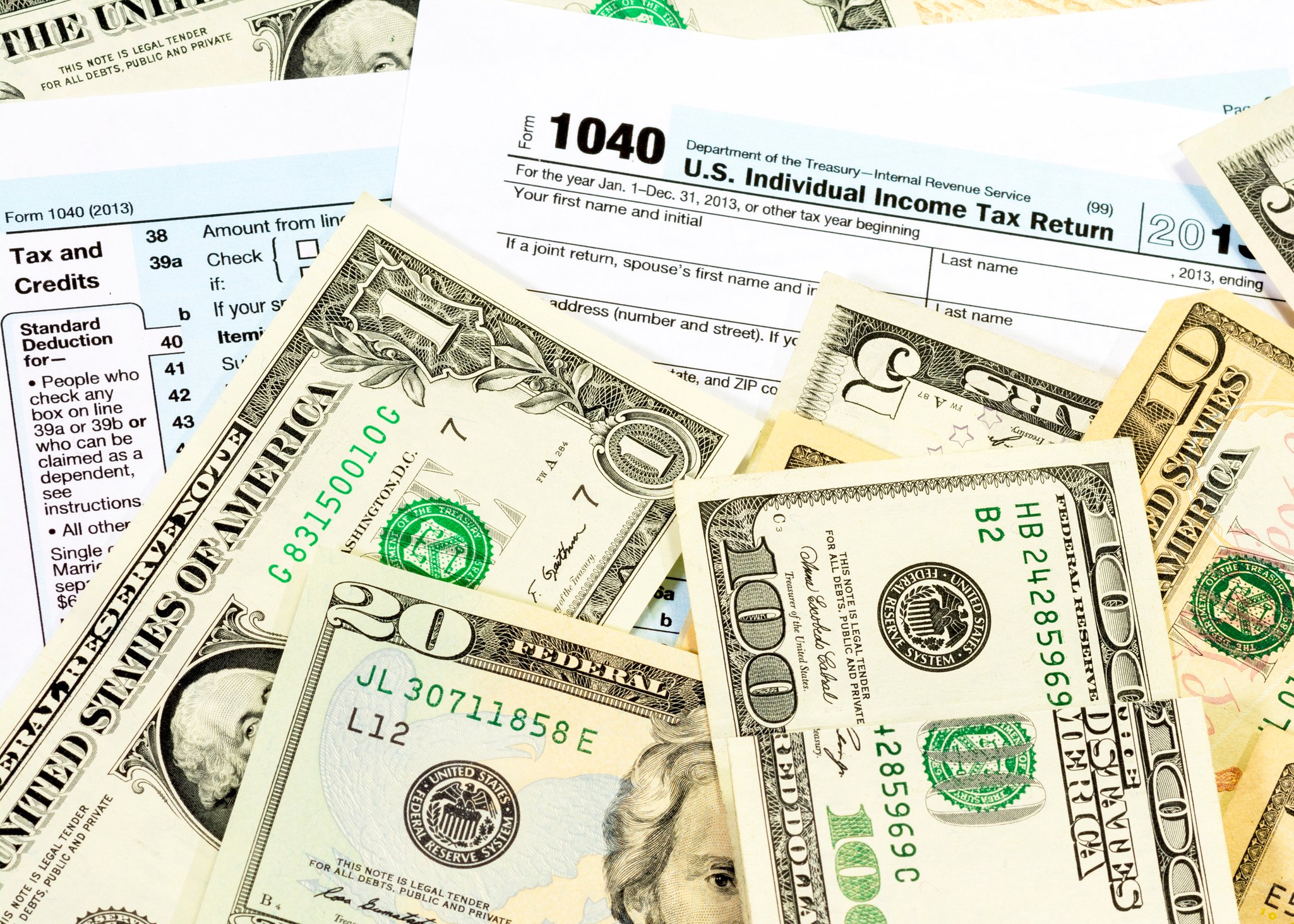 Form 1040 with money on top.