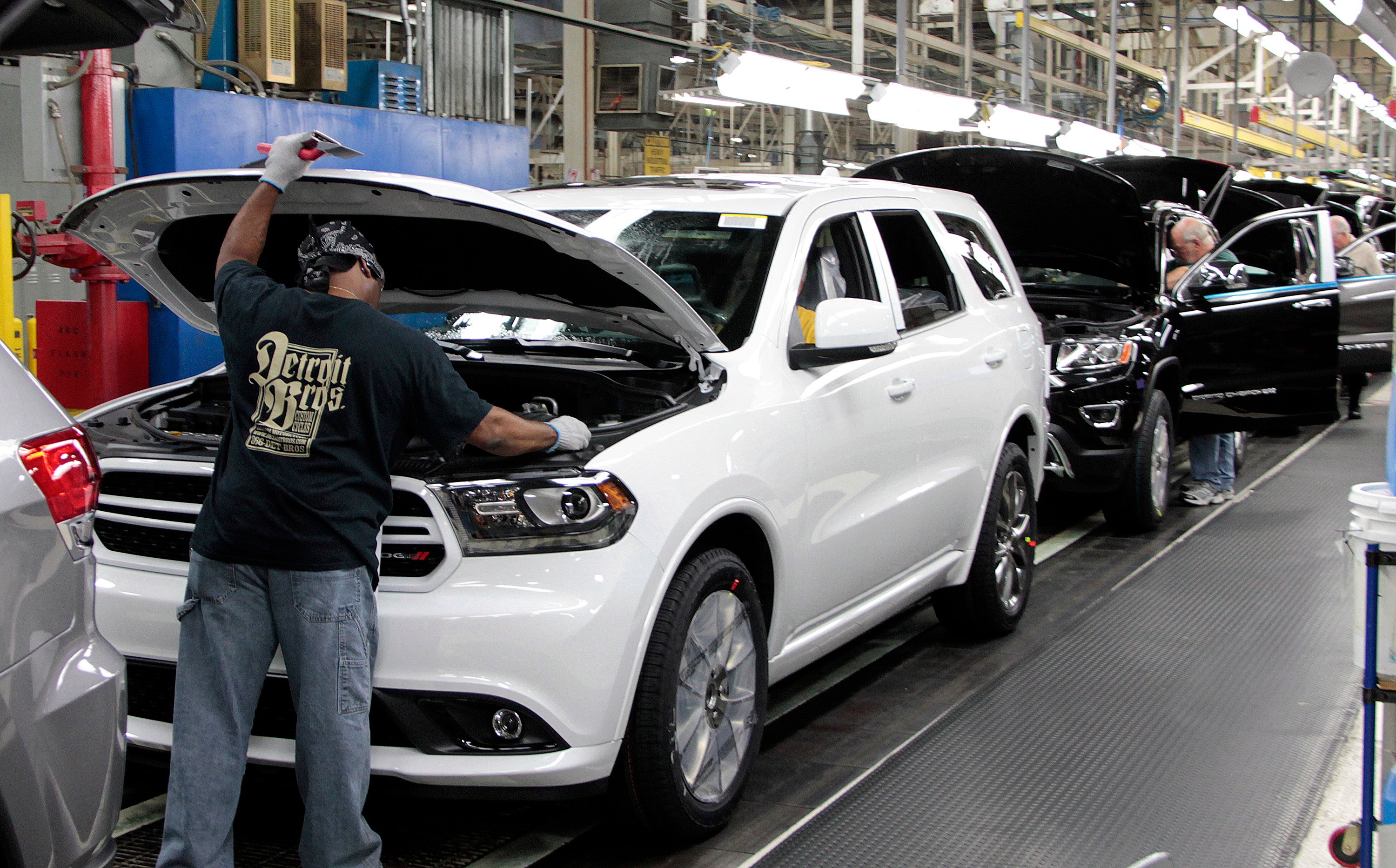 Dodge Durangos and Jeep Grand Cherokees on a factory assembly line.