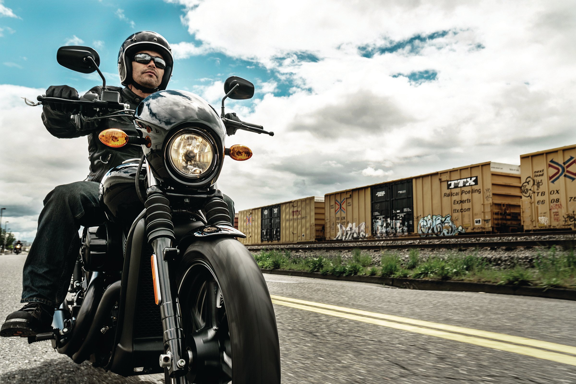 Man riding a Harley-Davidson motorcycle on street