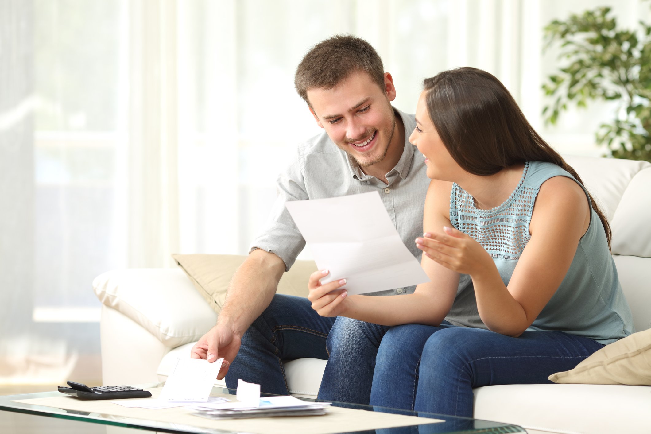Younger couple reading a letter.