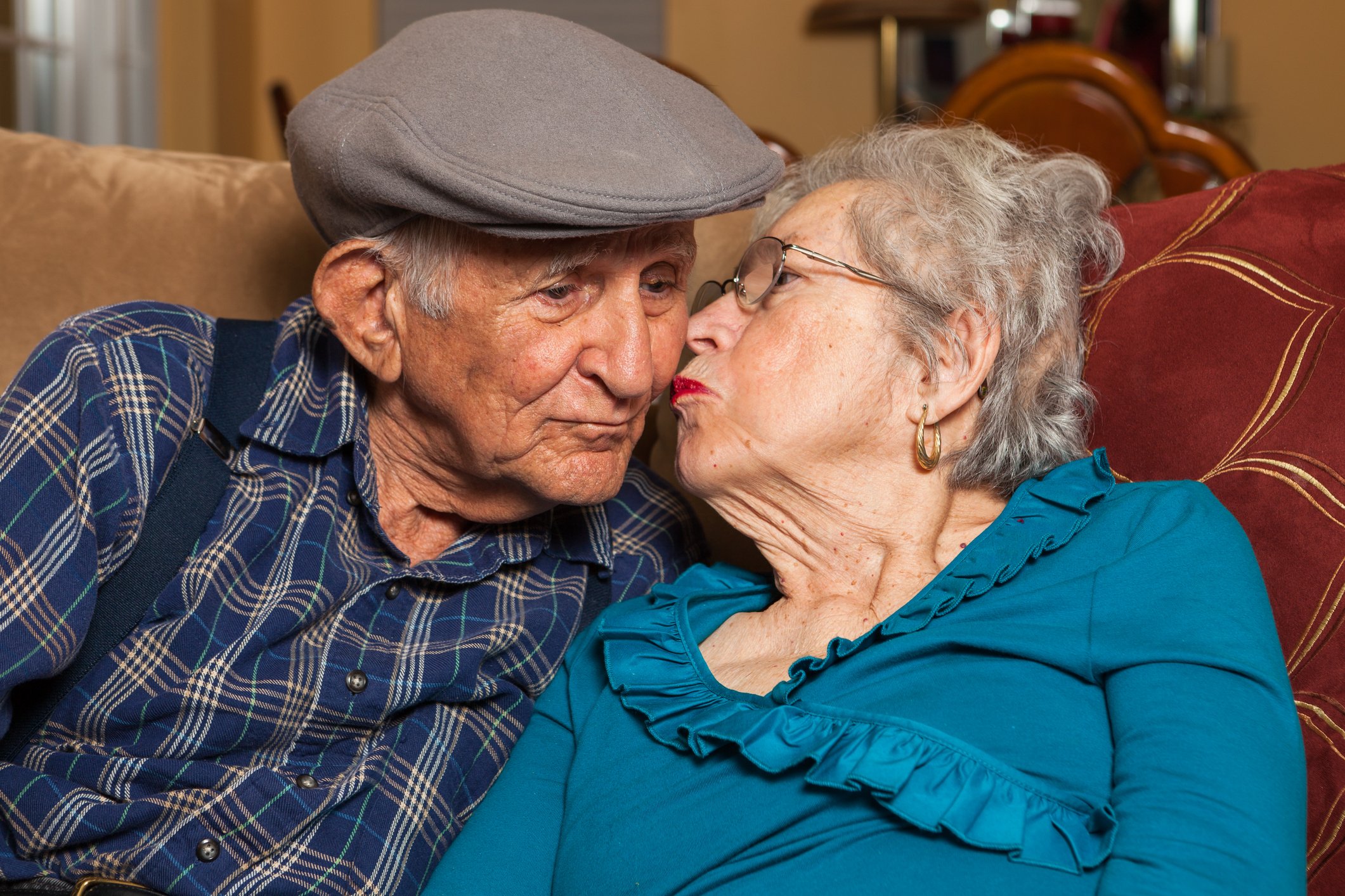 80-something couple on a sofa.