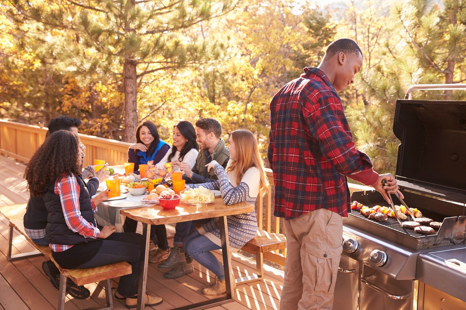 Family sharing a meal on their deck. 