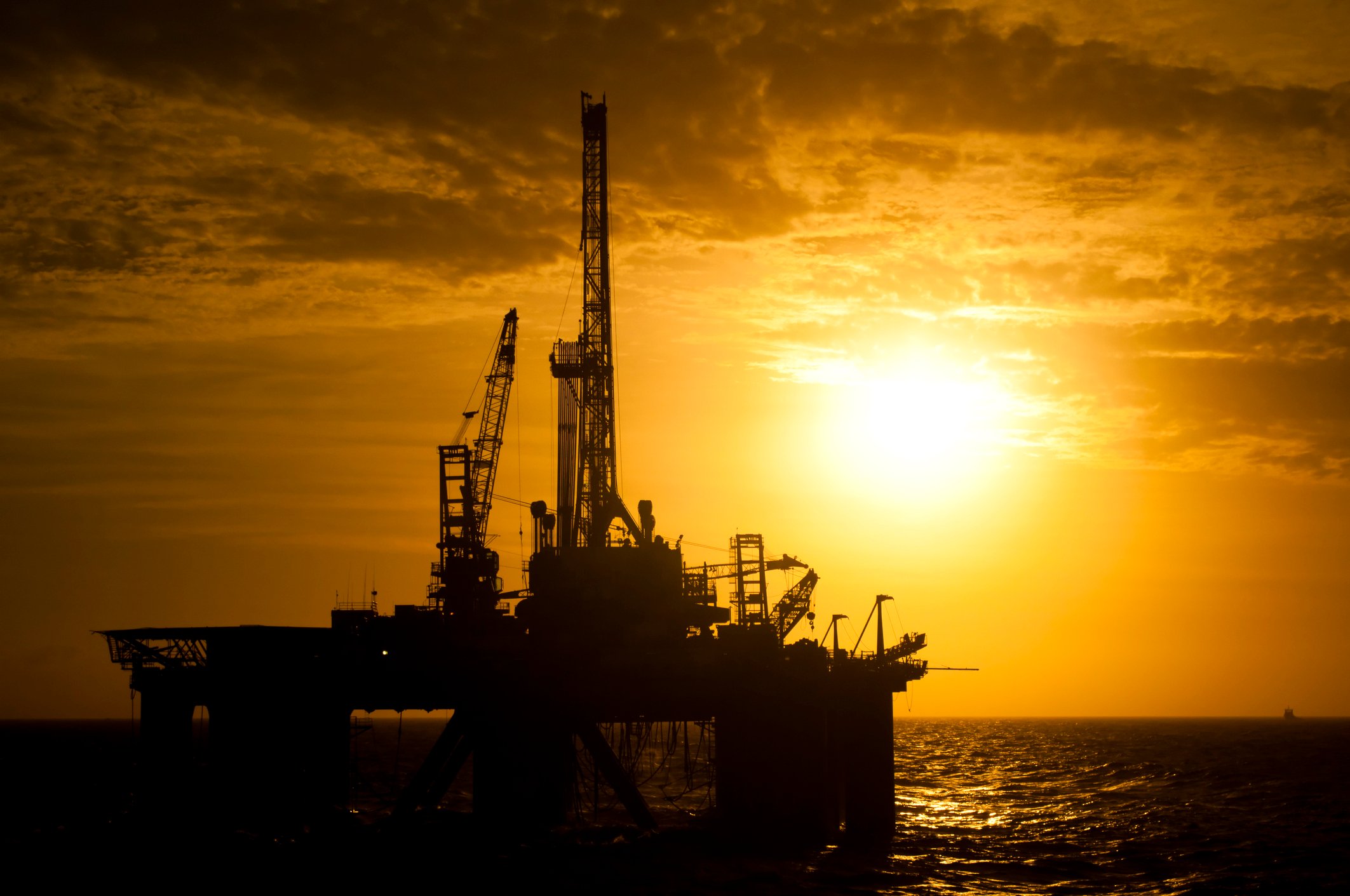 Offshore drill rig in silhouette