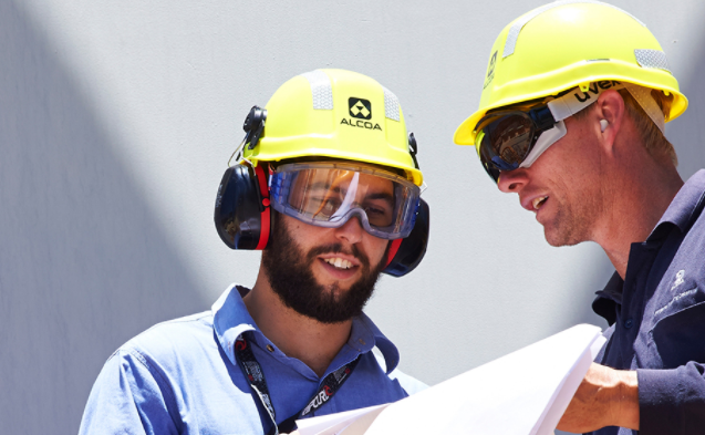 Two male Alcoa employees working together