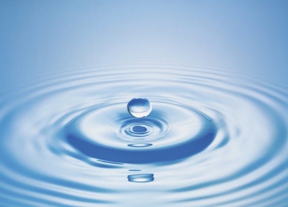 Drop of water falling into a body of water and the resultant ripple.