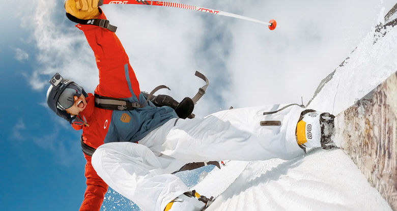 A man using a GoPro camera to record himself skiing.