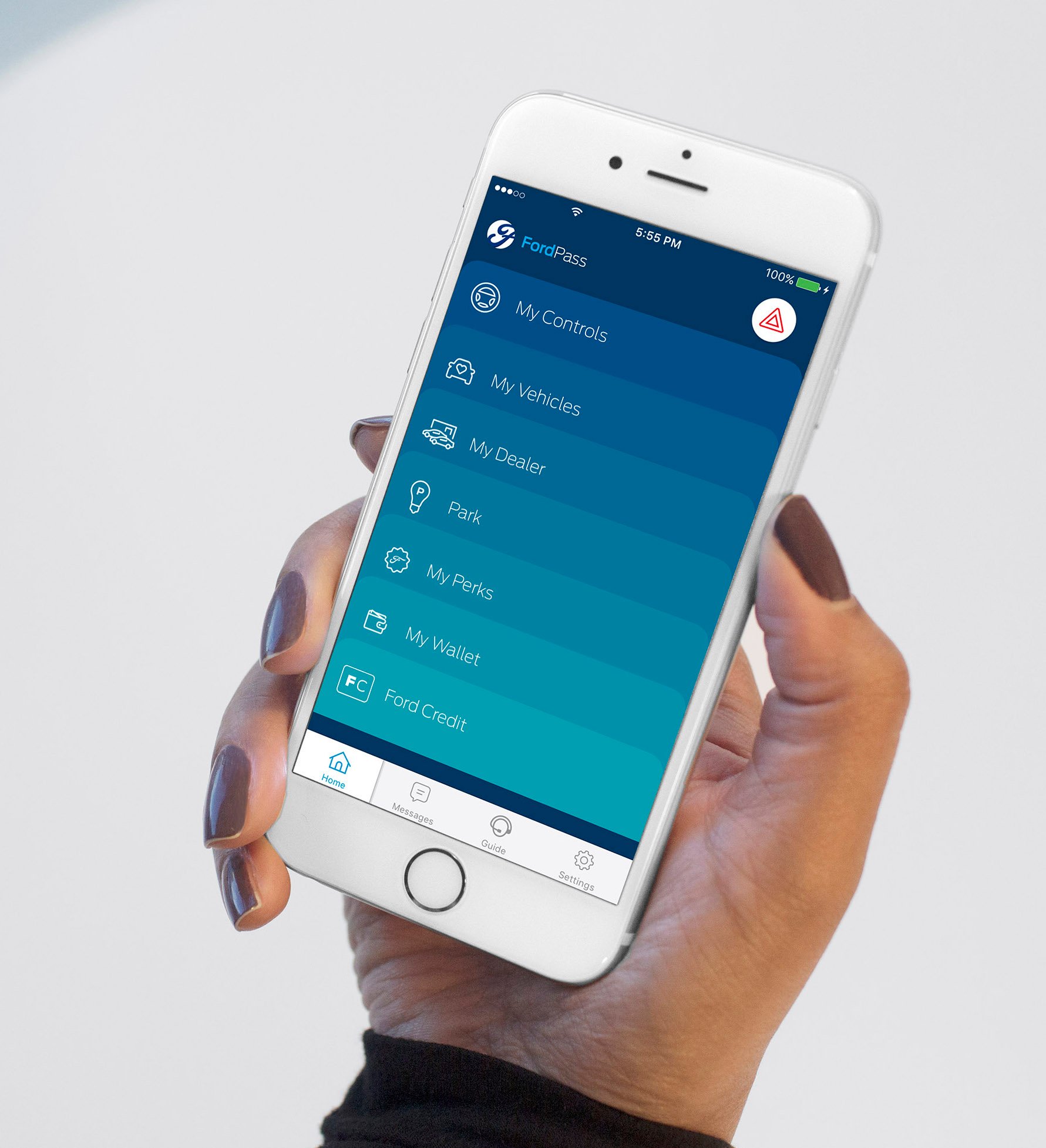A hand holding a white iPhone showing the FordPass app's menu screen.