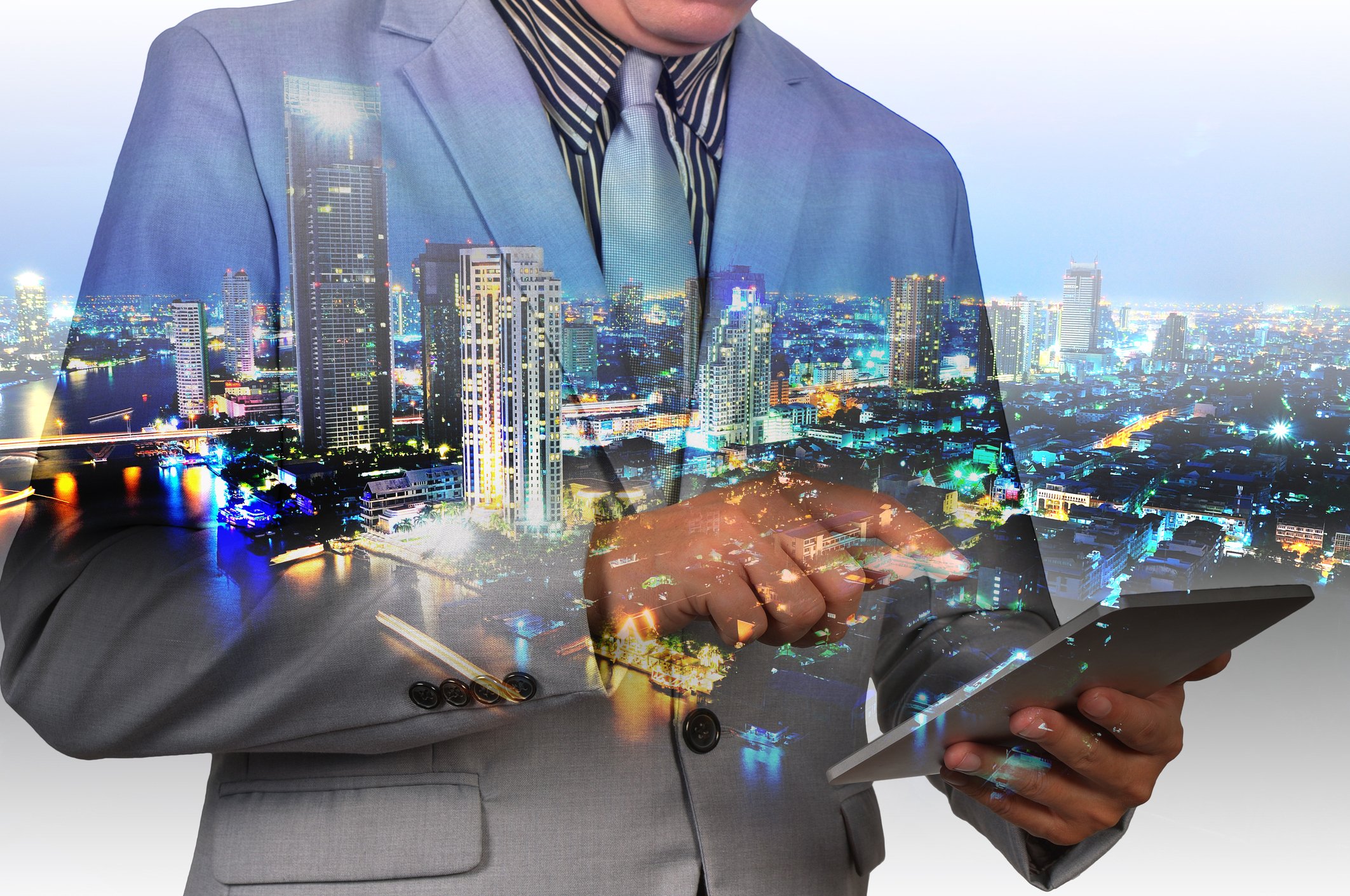 Man looking at real estate information on a tablet.