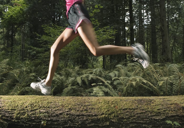 A jogger running through the forest.