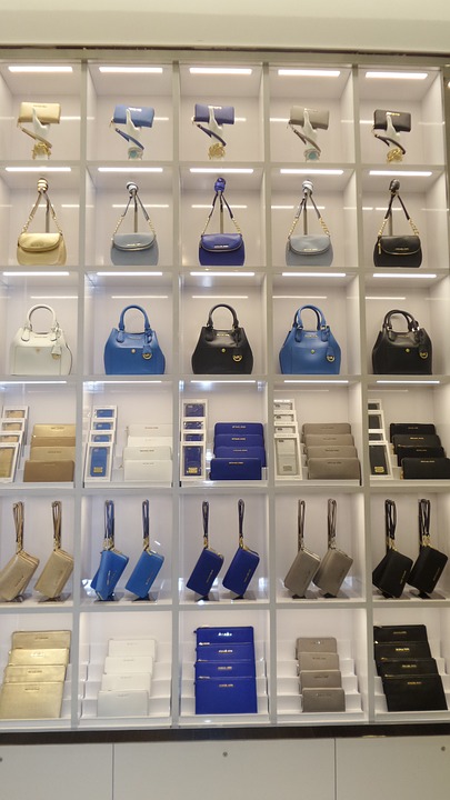 Purse rack in store featuring Michael Kors' products