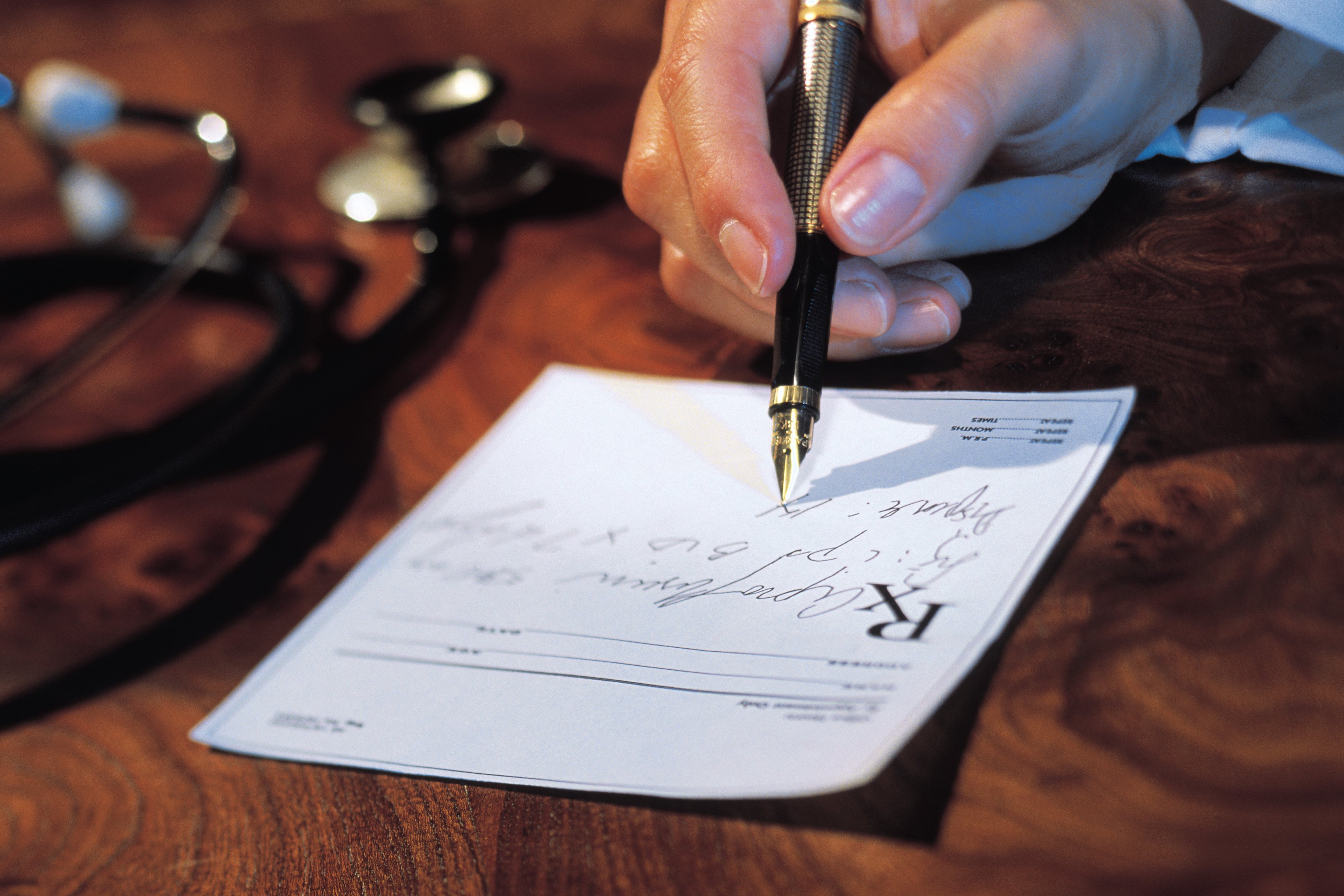 Doctor writing a prescription. 