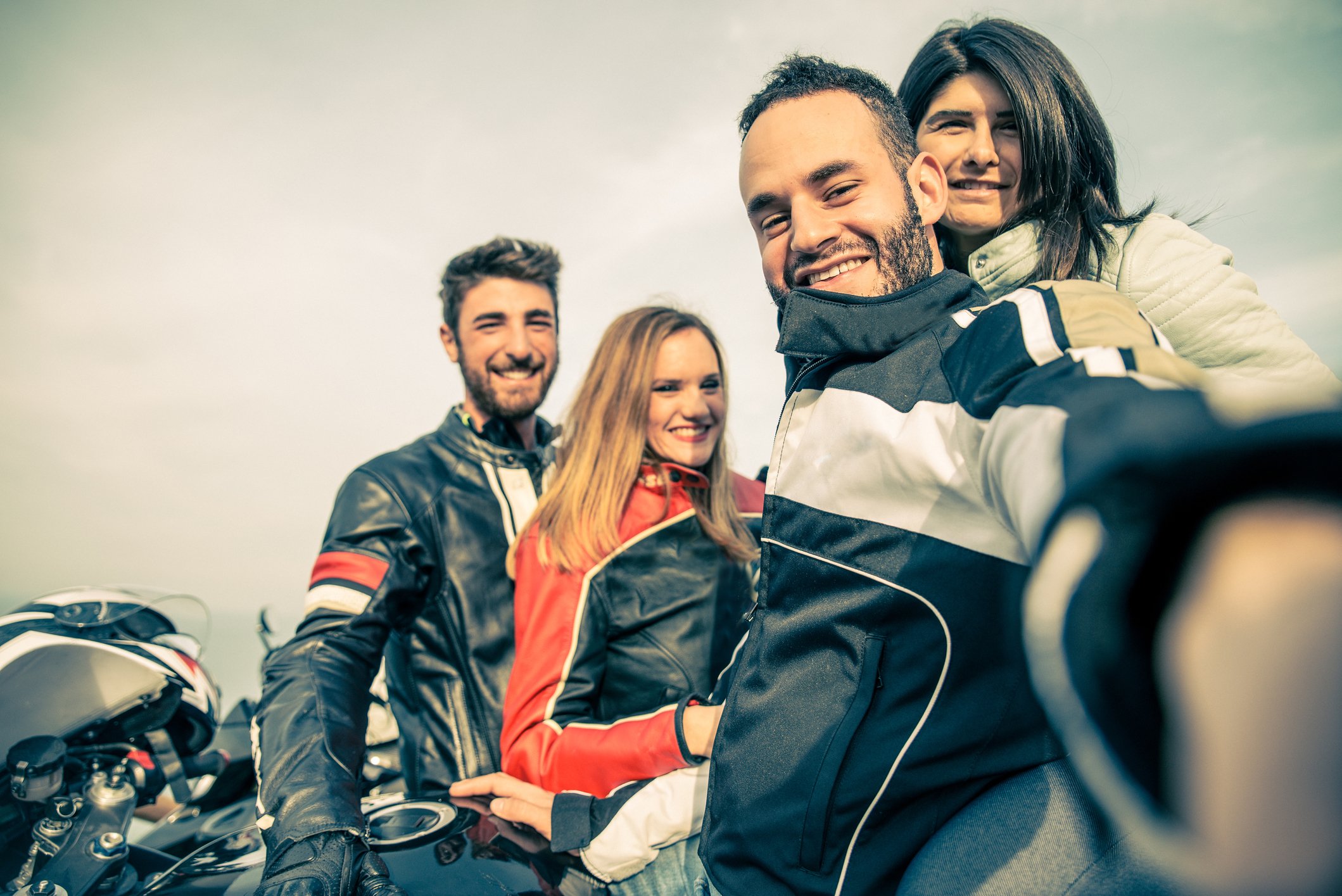 Two couples in motorcycle riding gear