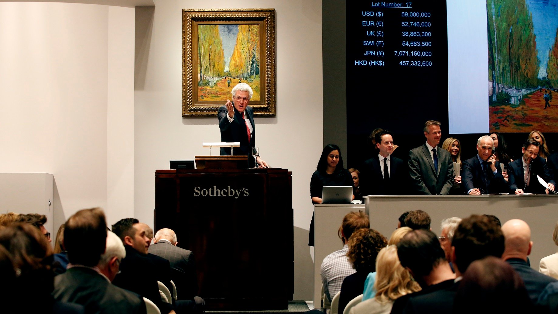 Auctioneer selling a painting.