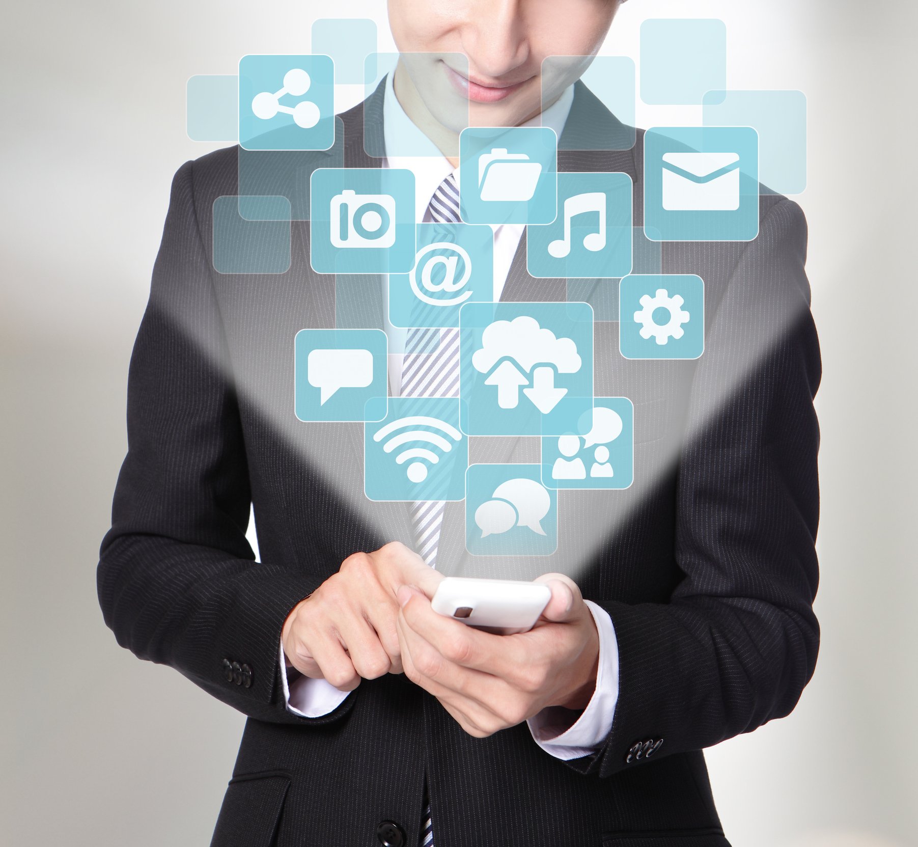 Man looking at his smart phone with various social media images being projected upwards.