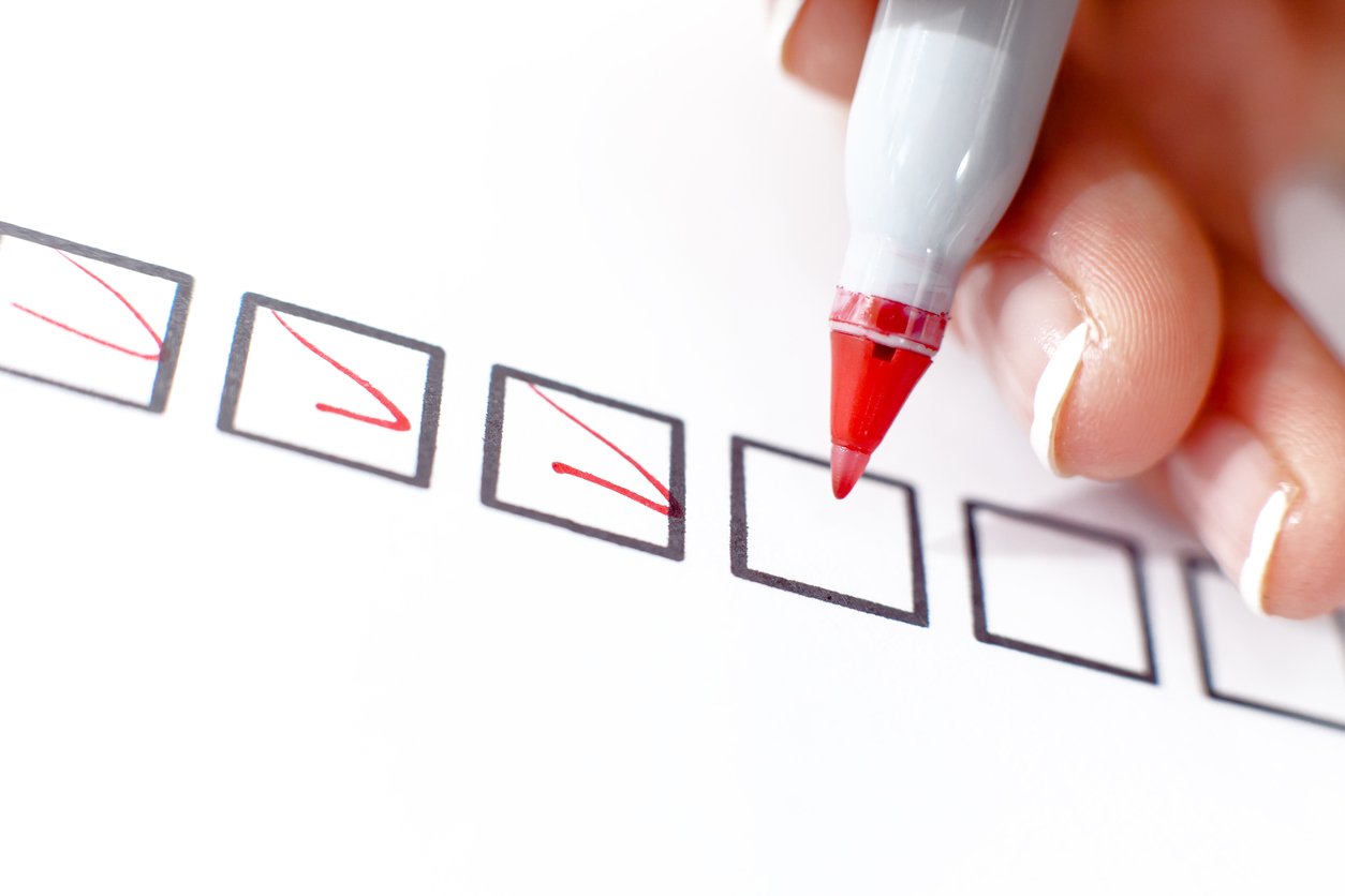 Boxes being checked off with a red pen.