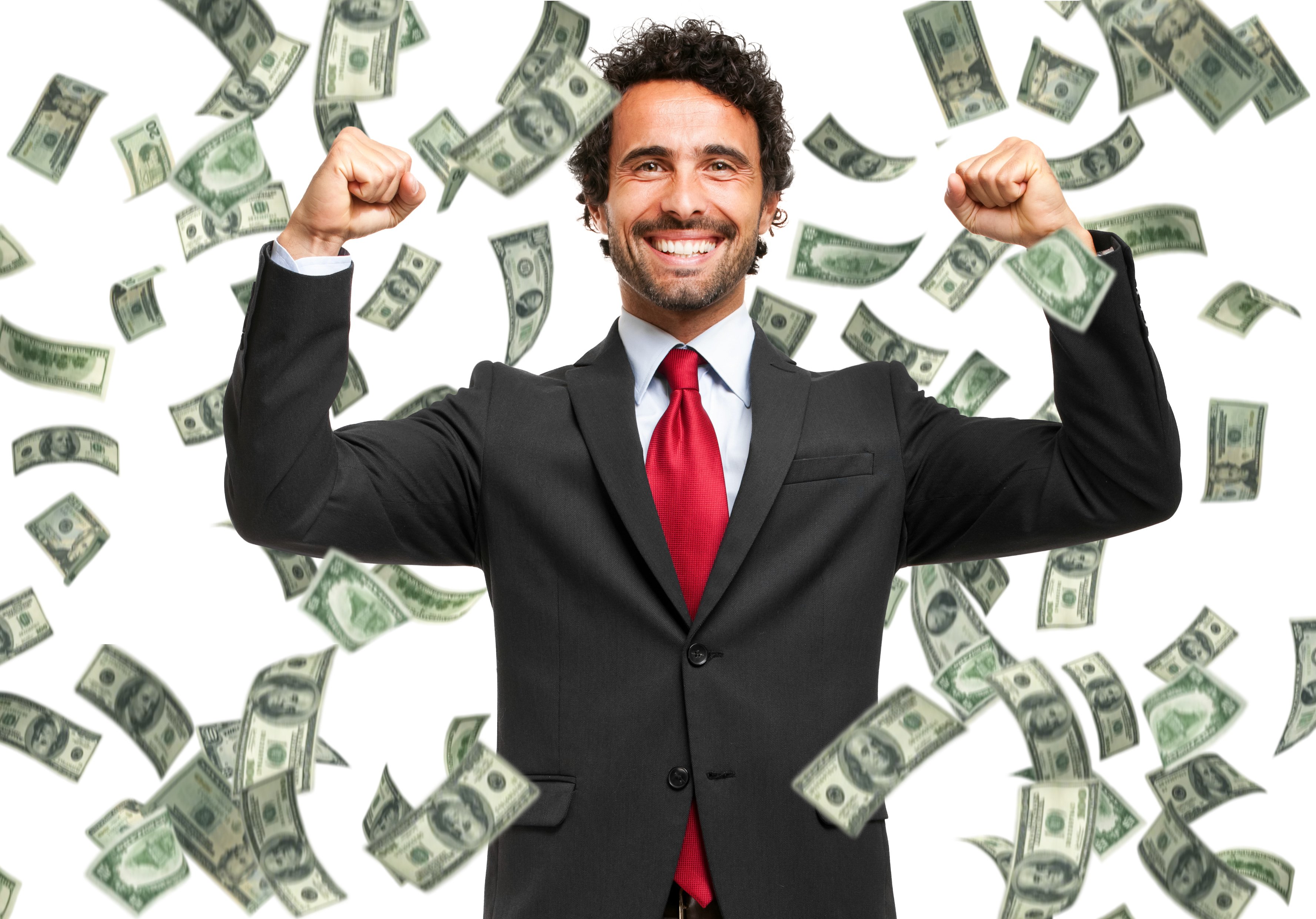 A businessman with arms raised stands as money falls down around him.