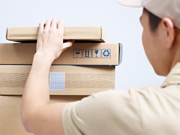 A worker grabs a package ready to be delivered.