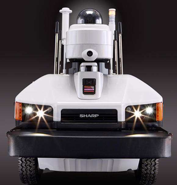 A Sharp Intellios A-UGV drone, which has a security camera mounted to the top of a small truck.