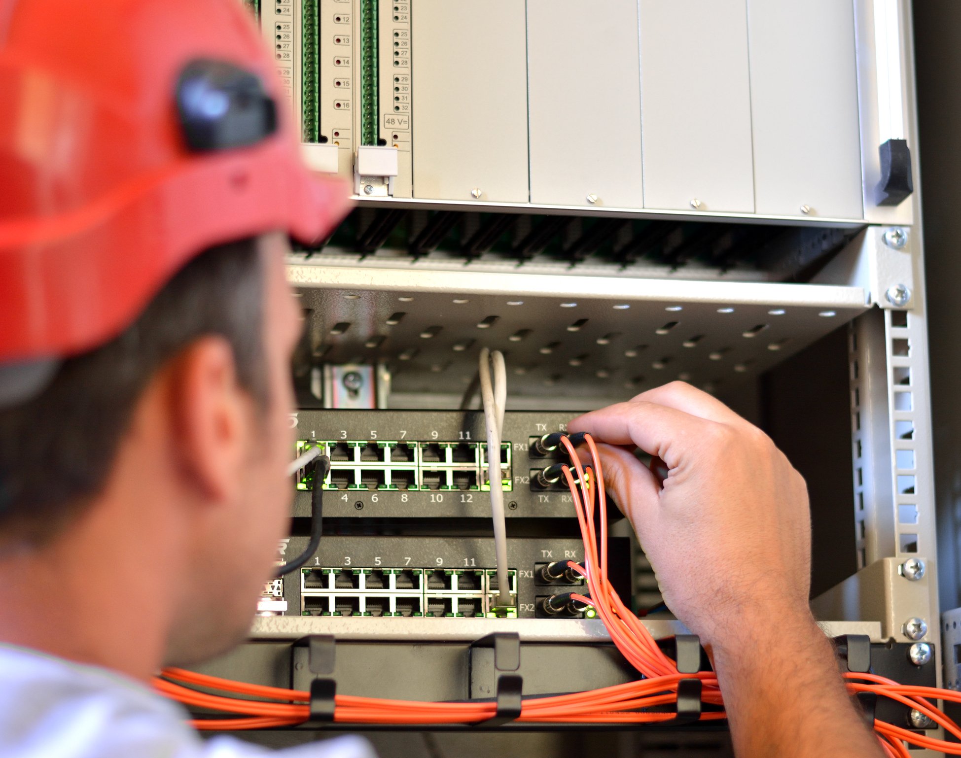 Technician hooking up cable fiber