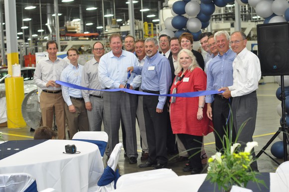 Employees celebrating a plant opening.