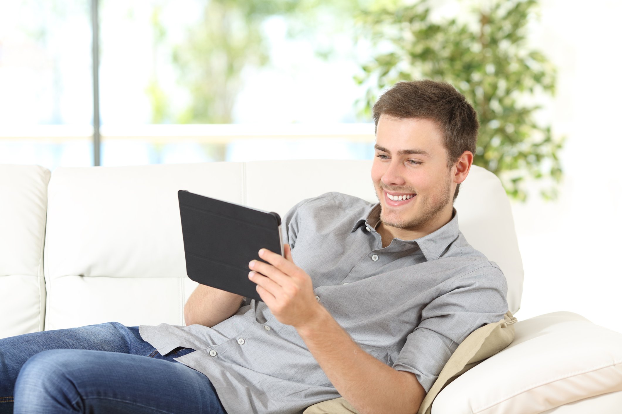 Happy man using a tablet.