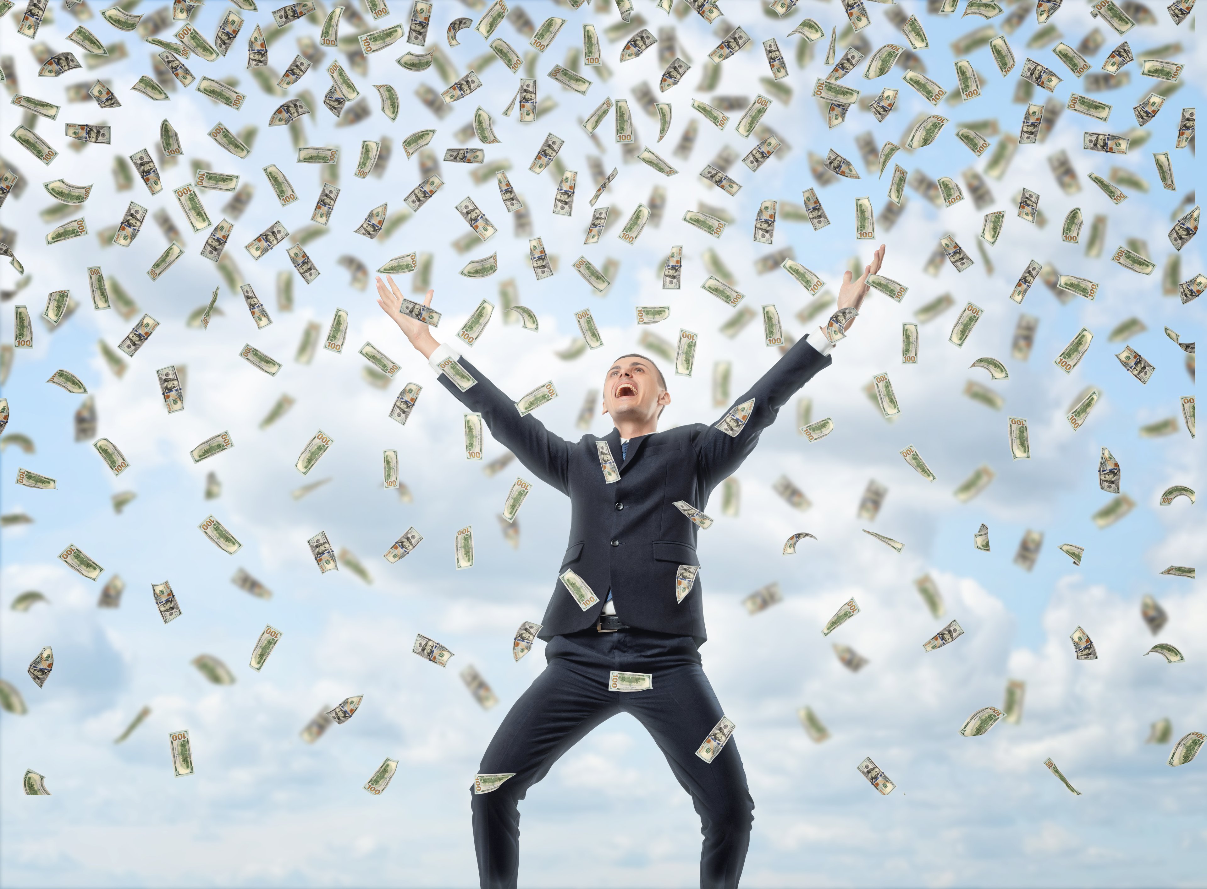 raining money on business man