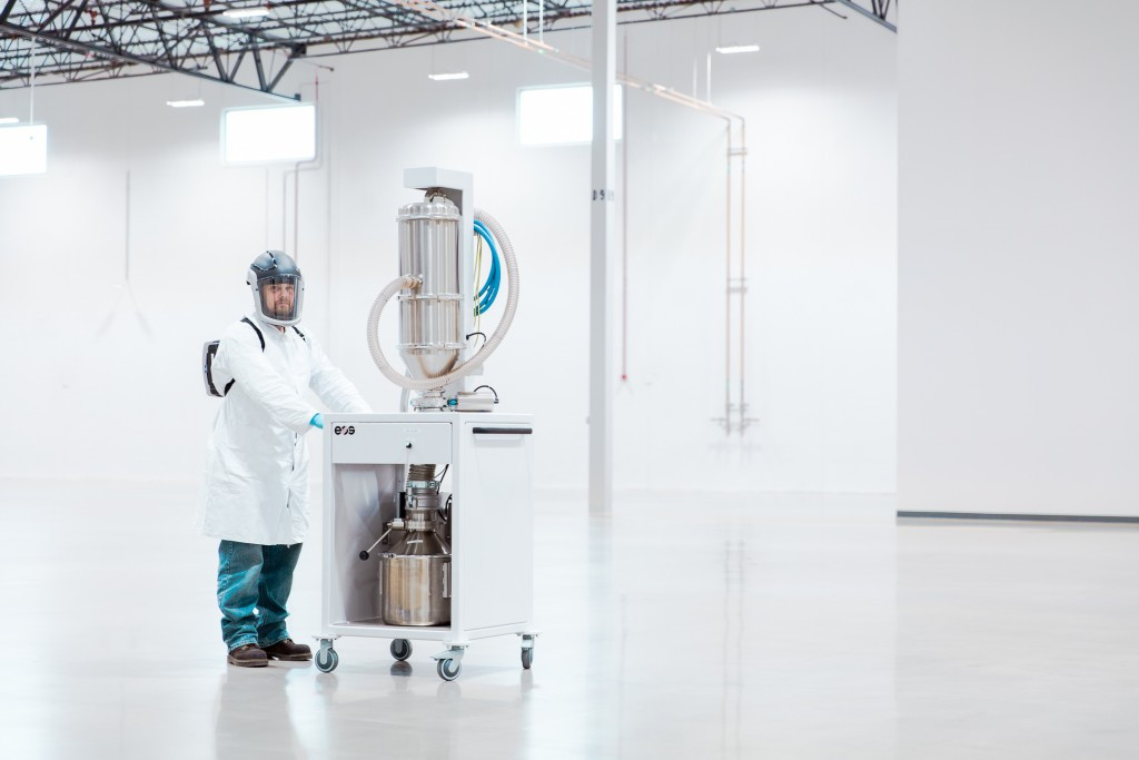 A worker standing at a machine in GE's center for additive technology advancement