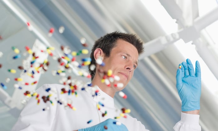 Scientists with pills in air