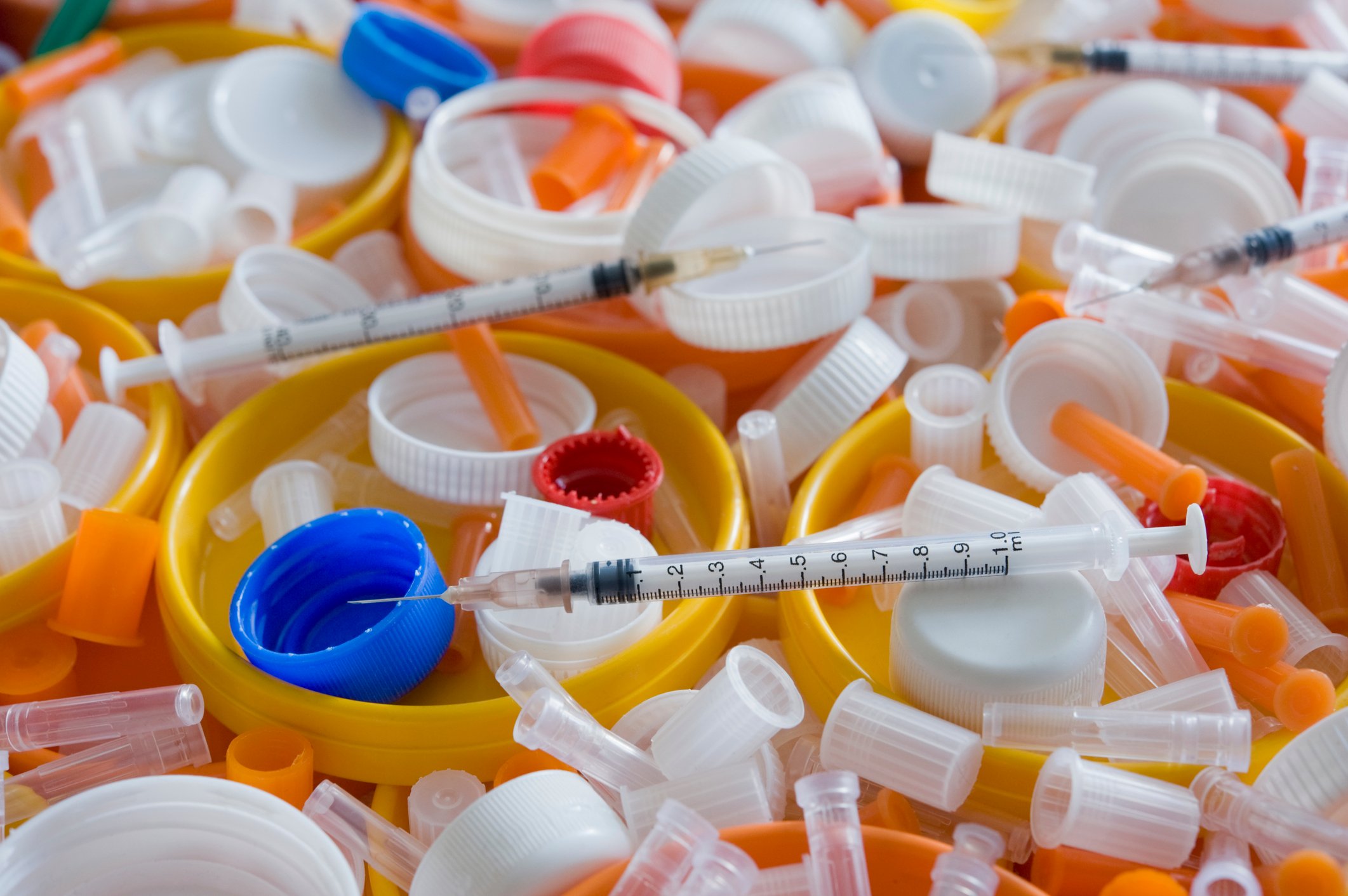 Discarded syringes and pill bottles.