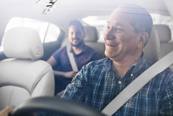 Uber driver talking with passenger.