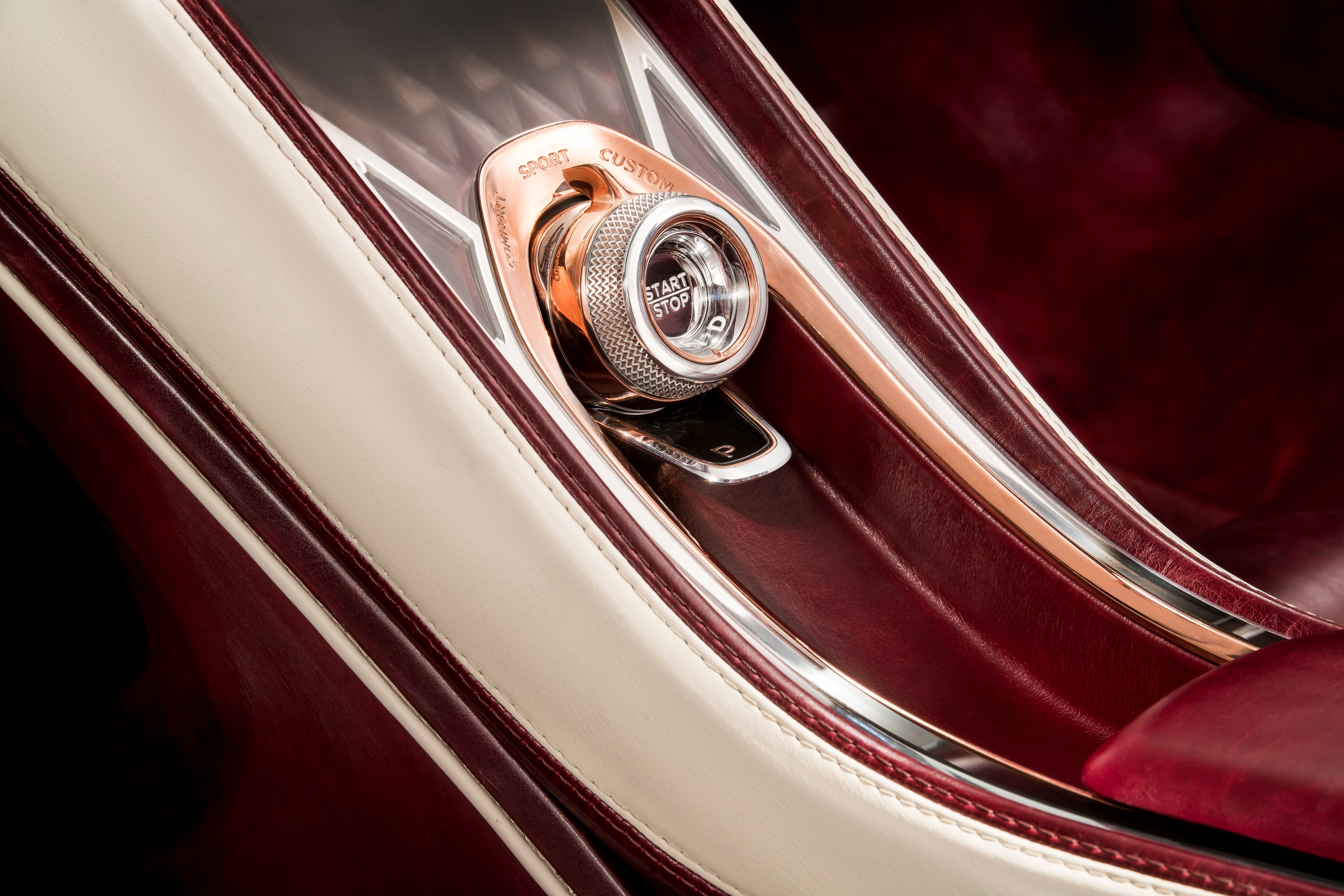 A close-up of the glass "Start" button in the Bentley EXP 12 Speed 6e Concept. 