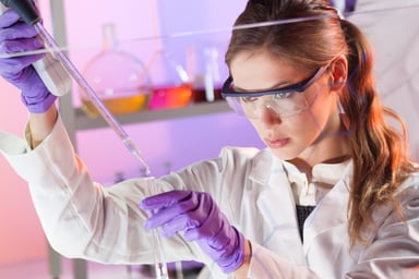 Female scientist with pipette in lab