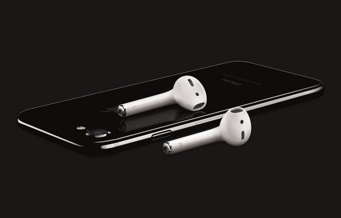 Apple's iPhone 7 in Jet Black accompanied by a pair of AirPod wireless earbuds. 