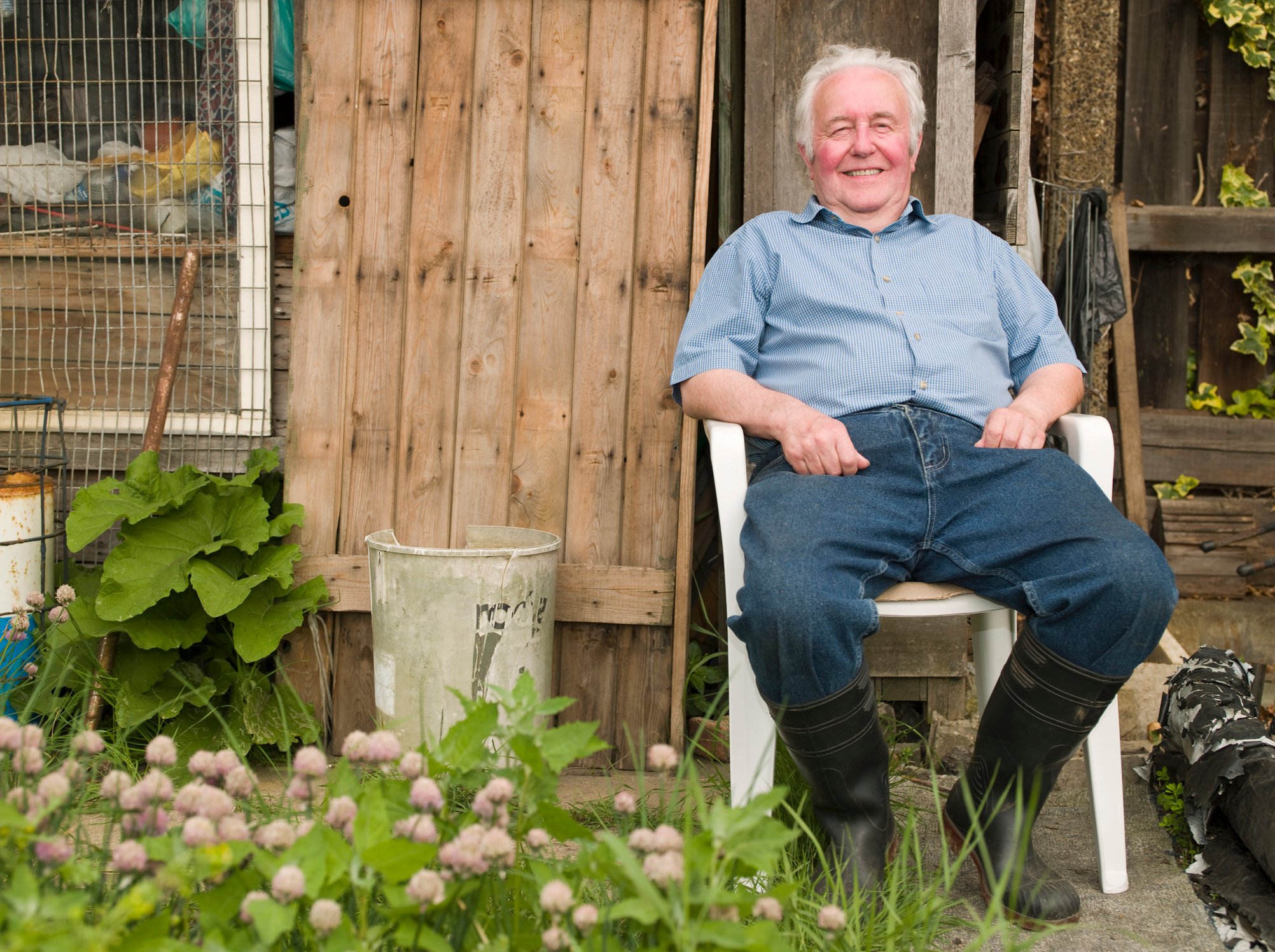Senior man sitting in a garden