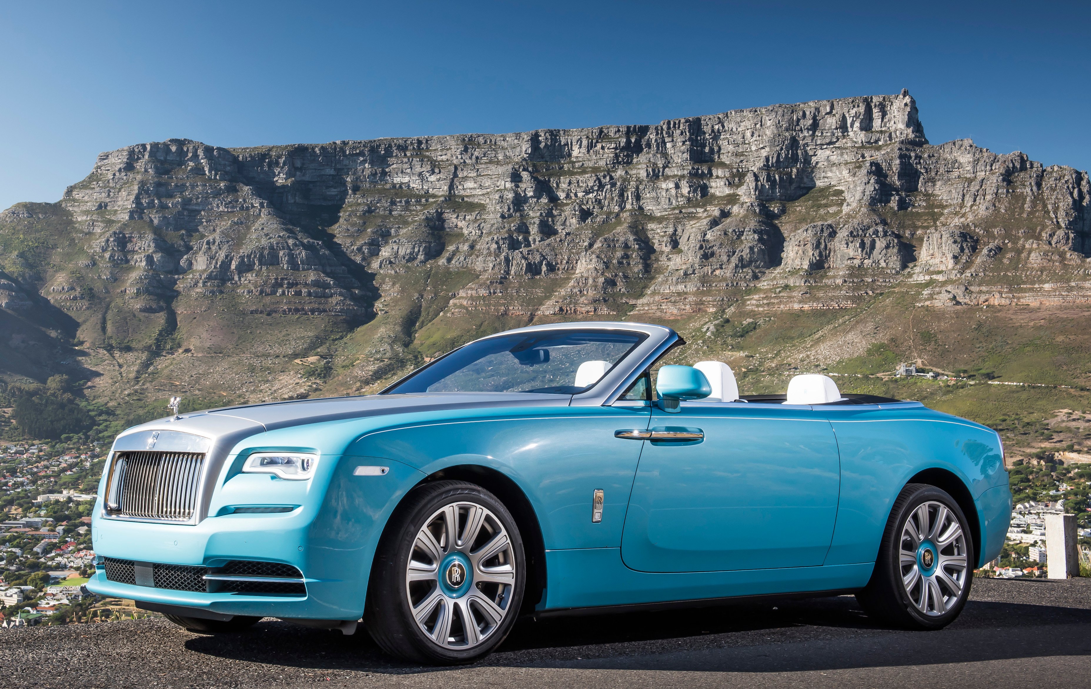 A robin's-egg blue Rolls-Royce Dawn 2-door convertible. 