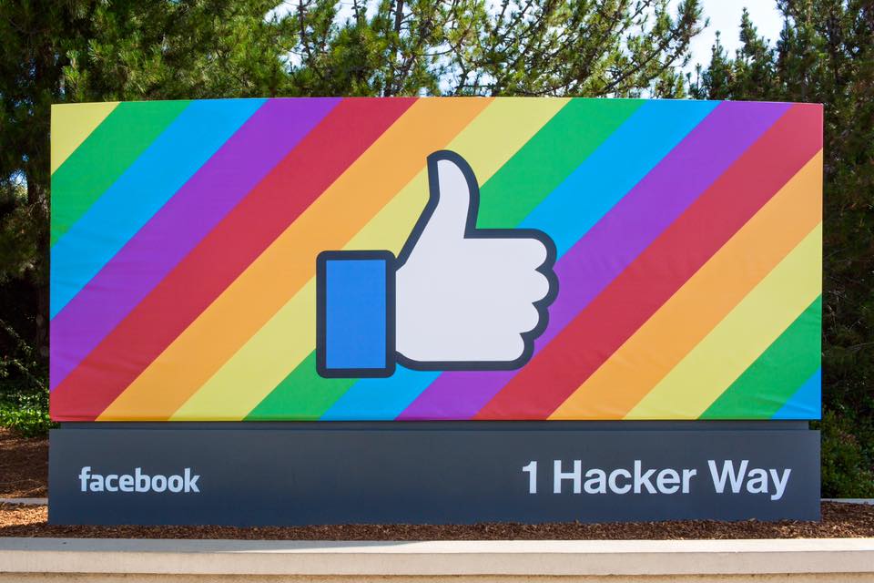 Image of the entrance to Facebook's corporate campus at 1 Hacker Way, featuring the thumbs-up from its "Like" feature.