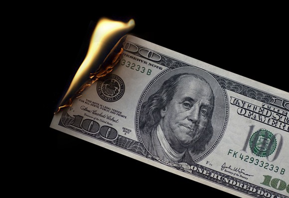 $100 bill on fire. 