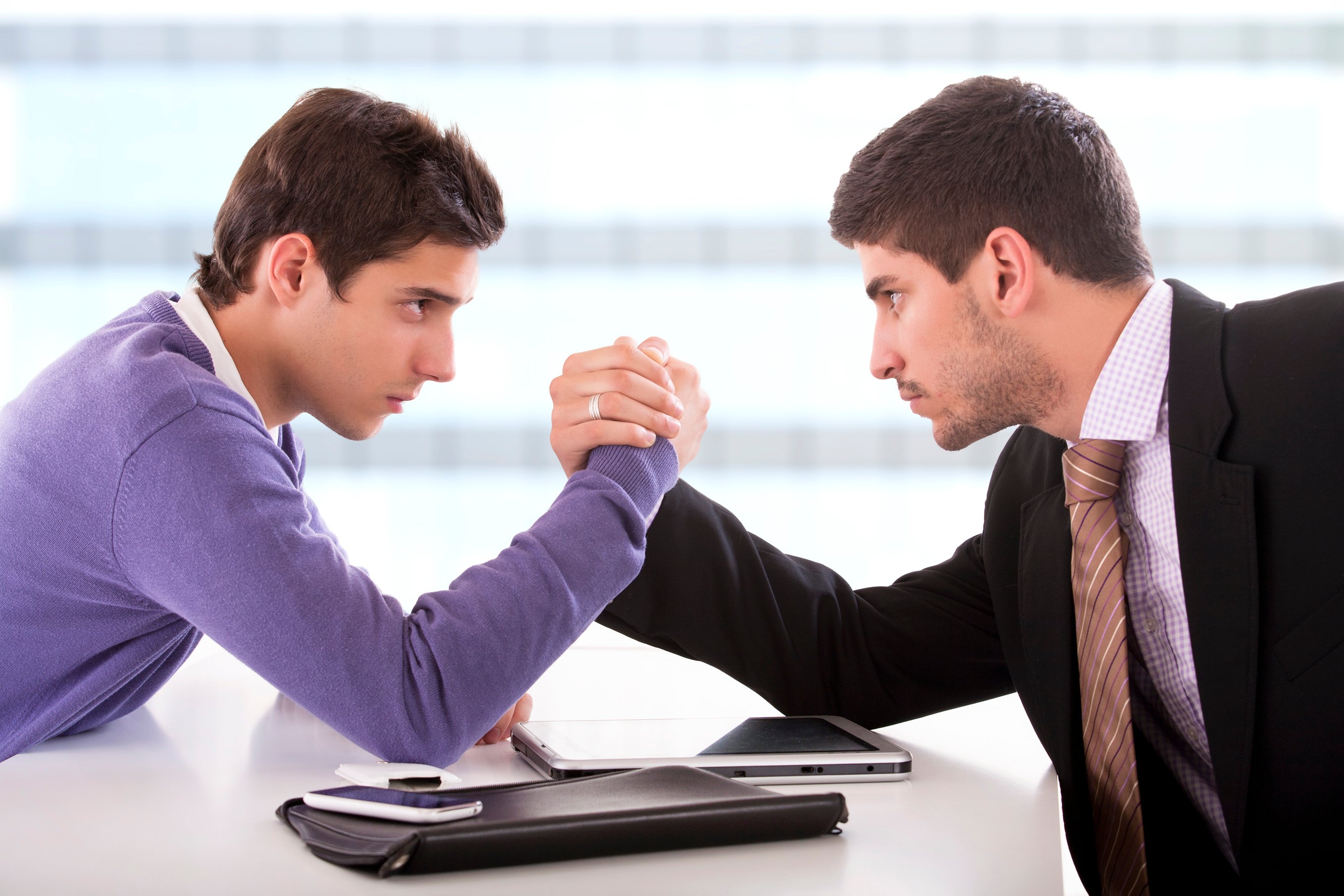 Two businessmen arm wrestling