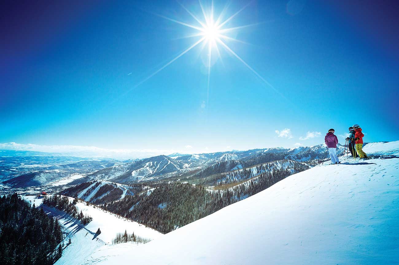 Mountaintop view with skiers looking down.