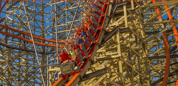 People riding a roller coaster.
