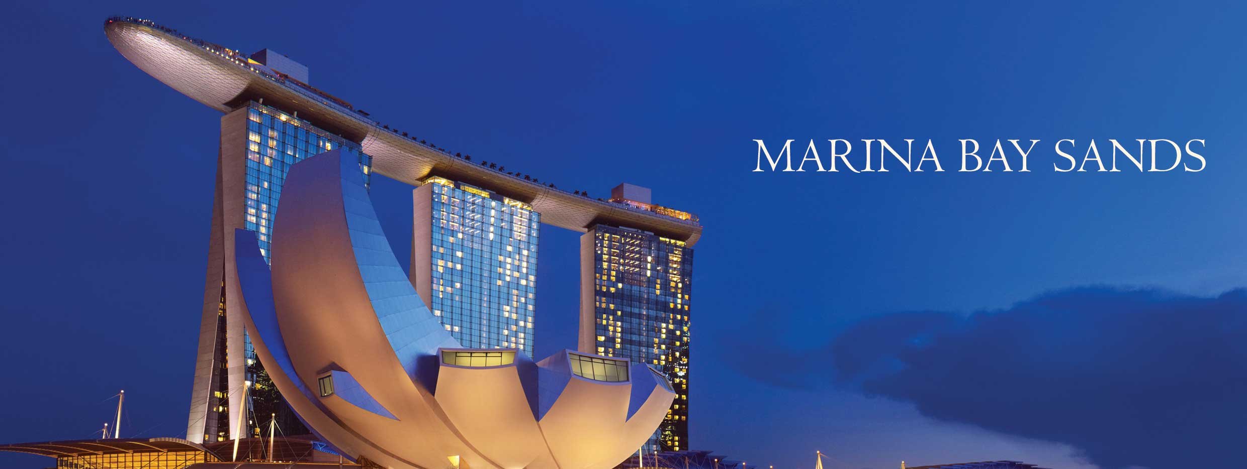 The Marina Bay Sands resort shaped like a boat atop three hotel towers sets right on the bay in Singapore.