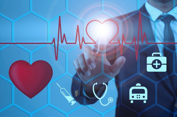 Man pointing to screen with healthcare symbols