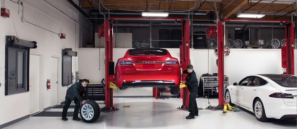 Tesla technicians performing service on a Model S