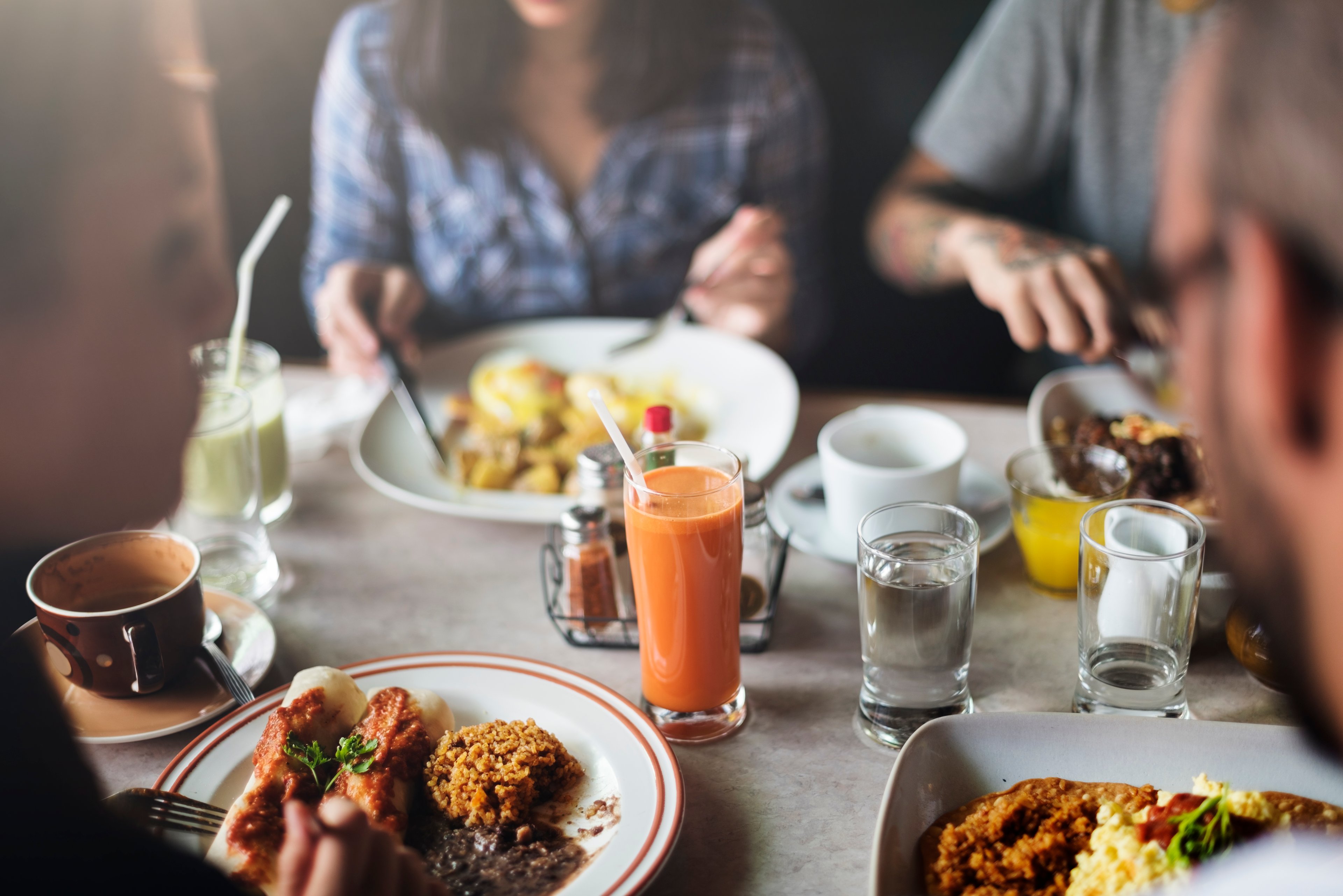 A group of people sitting around a restaurant table
