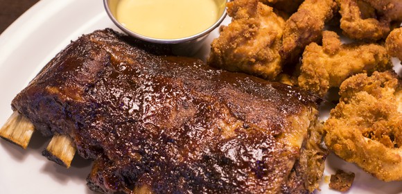 The "ultimate" catering feast featuring ribs, chicken tenders, and sides at Ruby Tuesday.