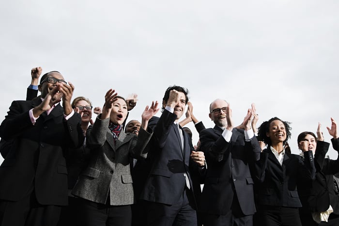 Business people clapping and cheering