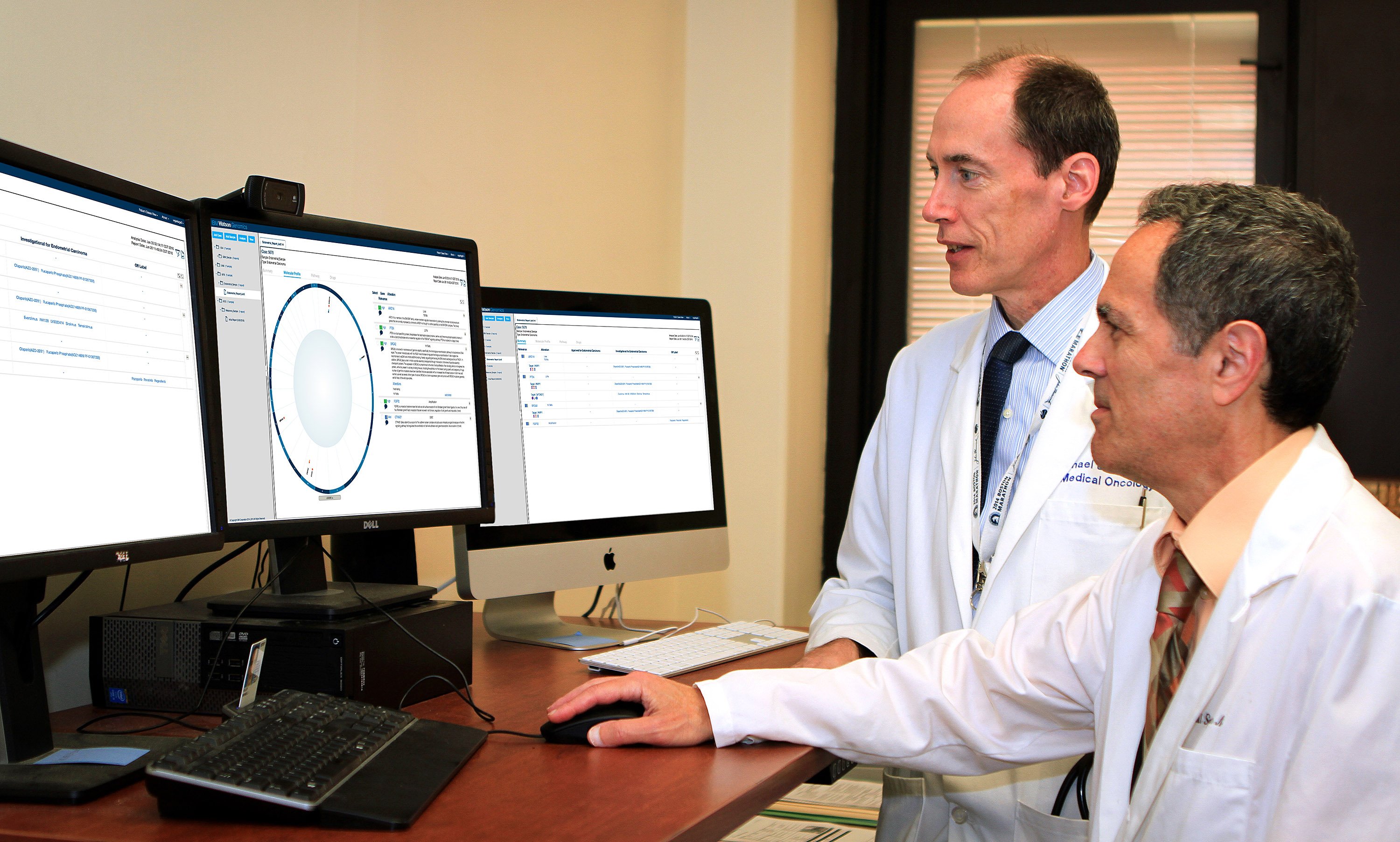 VA oncologists Michael Kelley and Neil Spector review a Watson for Genomics DNA analysis report.